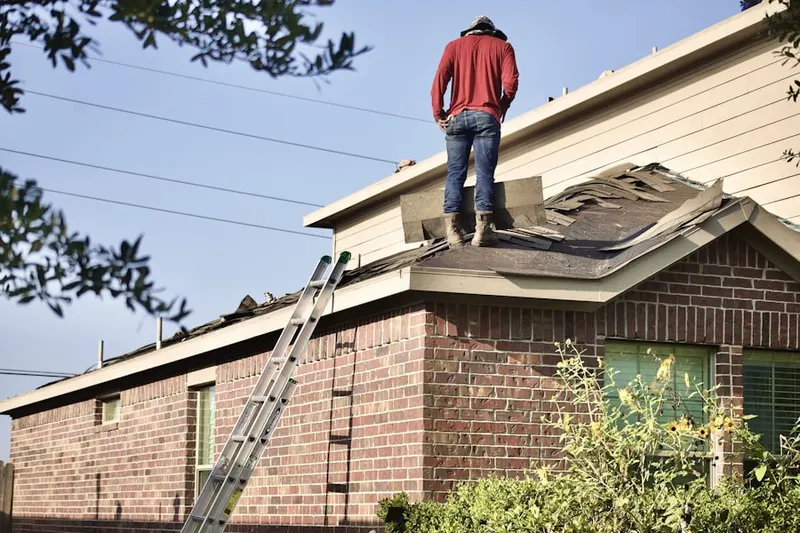 Professional roofer working on a residential roof in Culebra Park